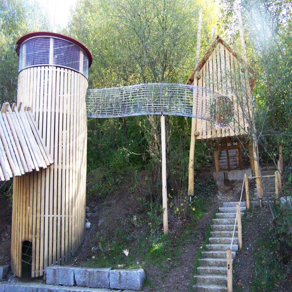 The Haar Egelfing is an incredible bespoke wooden climbing frame|a unique climbing frame with a mesh tunnel - very exciting landscape design.